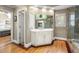 Elegant bathroom featuring a vanity with drawers and cabinets, wood flooring, and natural light at 11060 Pennbrooke Xing, Johns Creek, GA 30097