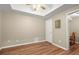 Light-filled bedroom featuring wood floors, white trim, and a connecting room with table and chairs at 11060 Pennbrooke Xing, Johns Creek, GA 30097
