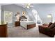 Cozy bedroom featuring a large bed, hardwood furniture, and sloped ceiling at 11060 Pennbrooke Xing, Johns Creek, GA 30097