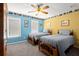 Bedroom with two beds, ceiling fan, and blue and yellow walls at 11060 Pennbrooke Xing, Johns Creek, GA 30097