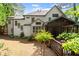 View of the back exterior with screen porch, plants and foliage at 11060 Pennbrooke Xing, Johns Creek, GA 30097