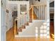 Bright foyer featuring hardwood floors and an elegant staircase with iron spindles at 11060 Pennbrooke Xing, Johns Creek, GA 30097