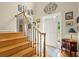 Elegant foyer with hardwood stairs, a decorative iron railing and tiled entrance at 11060 Pennbrooke Xing, Johns Creek, GA 30097