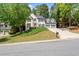 Inviting home with a manicured lawn, three-car garage, and classic architectural details creating excellent curb appeal at 11060 Pennbrooke Xing, Johns Creek, GA 30097