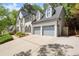 Beautiful home featuring a three car garage and brick driveway at 11060 Pennbrooke Xing, Johns Creek, GA 30097