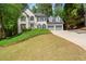 Beautiful home with an attached three-car garage, green lawn, and classic design, perfect for Gathering living and entertaining at 11060 Pennbrooke Xing, Johns Creek, GA 30097