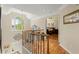Open hallway with hardwood floors offering views to front door and the bedroom at 11060 Pennbrooke Xing, Johns Creek, GA 30097