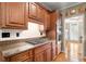 Kitchen with granite countertops, stainless steel appliances, tile backsplash, and wood cabinetry at 11060 Pennbrooke Xing, Johns Creek, GA 30097