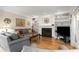 Comfortable living room with hardwood floors, fireplace, and custom built-in shelving at 11060 Pennbrooke Xing, Johns Creek, GA 30097