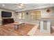Spacious living room with ceiling fan, recessed lighting, wood flooring, and windows at 11060 Pennbrooke Xing, Johns Creek, GA 30097