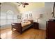 Spacious main bedroom with hardwood floors, a decorative ceiling, and ample natural light at 11060 Pennbrooke Xing, Johns Creek, GA 30097