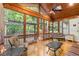 Bright sunroom features natural light, ceiling fan, and serene outdoor views at 11060 Pennbrooke Xing, Johns Creek, GA 30097