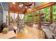 Relaxing sunroom with wood ceiling, skylights, and screened windows with nature views at 11060 Pennbrooke Xing, Johns Creek, GA 30097