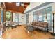 Cozy sunroom with wood beam ceiling, fan, and multiple windows for natural light at 11060 Pennbrooke Xing, Johns Creek, GA 30097