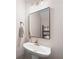 Bathroom featuring modern pedestal sink, chrome faucet, and stylish mirror at 1396 Dolcetto Nw Trce # 12, Kennesaw, GA 30152