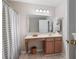 Bathroom features a vanity with solid surface countertop and tub and shower with tile surround at 1396 Dolcetto Nw Trce # 12, Kennesaw, GA 30152