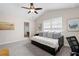 Bright bedroom features a daybed with storage, neutral walls, a ceiling fan, and an ensuite bathroom at 1396 Dolcetto Nw Trce # 12, Kennesaw, GA 30152