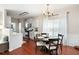Open dining area with hardwood floors, a chandelier, and kitchen access at 1396 Dolcetto Nw Trce # 12, Kennesaw, GA 30152