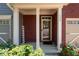 Covered entryway featuring brick pillars, a 'welcome' sign, and vibrant greenery at 1396 Dolcetto Nw Trce # 12, Kennesaw, GA 30152