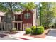Two-story townhome with brick facade, an attached garage, and a well-maintained lawn at 1396 Dolcetto Nw Trce # 12, Kennesaw, GA 30152