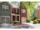 Charming brick and siding townhome with a two-car garage and manicured landscaping at 1396 Dolcetto Nw Trce # 12, Kennesaw, GA 30152