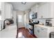 Well-lit kitchen features white cabinets, stainless steel appliances, and a stylish farmhouse sink at 1396 Dolcetto Nw Trce # 12, Kennesaw, GA 30152