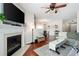 Comfortable living room with a fireplace, hardwood flooring, and ample natural light at 1396 Dolcetto Nw Trce # 12, Kennesaw, GA 30152