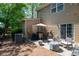 Outdoor patio with an umbrella table, chairs, and cafe lighting at 1396 Dolcetto Nw Trce # 12, Kennesaw, GA 30152