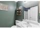 The olive bathroom has a white sink, vanity and decorative shelving at 257 Browning Cir, Acworth, GA 30101
