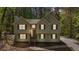 Charming home with light siding, green shutters, and a neatly landscaped front yard with mature trees at 257 Browning Cir, Acworth, GA 30101