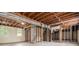 Unfinished basement with exposed ceiling beams and framing, offering potential for customization at 3500 Finesse Dr, Decatur, GA 30032