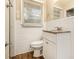 Cozy bathroom featuring a granite countertop, white cabinets, and a window with natural light at 3500 Finesse Dr, Decatur, GA 30032