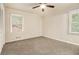 Cozy bedroom with neutral carpeting, ample natural light from two windows, and a ceiling fan at 3500 Finesse Dr, Decatur, GA 30032