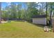 Expansive backyard with a storage shed, fire pit, and ample green space for outdoor activities at 4150 Spring Ridge Dr, Cumming, GA 30028