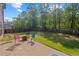 Spacious backyard featuring a patio, fire pit, and well-maintained lawn at 4150 Spring Ridge Dr, Cumming, GA 30028