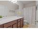 Neutral bathroom with a long vanity, large mirror, and shower curtain at 4150 Spring Ridge Dr, Cumming, GA 30028