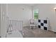 Bedroom with a crib, glider, and storage, ready for a new baby at 4150 Spring Ridge Dr, Cumming, GA 30028