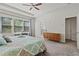 Bedroom with a ceiling fan, built-in desk, and neutral gray walls at 4150 Spring Ridge Dr, Cumming, GA 30028
