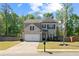 Charming brick front exterior with a well-maintained lawn and two-car garage at 4150 Spring Ridge Dr, Cumming, GA 30028