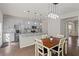 Bright kitchen with an island, gray cabinets and a dining table with seating for four at 4150 Spring Ridge Dr, Cumming, GA 30028