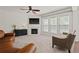 Cozy living room with a fireplace, a ceiling fan, and lots of natural light at 4150 Spring Ridge Dr, Cumming, GA 30028