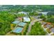 Aerial view showcases a community pool, tennis courts, playground, and a scenic lake at 1026 Towne Mill Xing, Canton, GA 30114