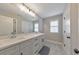 Bright bathroom featuring a double vanity, large mirror, and modern fixtures at 1026 Towne Mill Xing, Canton, GA 30114