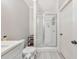 Bright bathroom featuring a glass door shower with gray tile flooring and a clean white vanity at 1026 Towne Mill Xing, Canton, GA 30114
