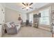 Cozy bedroom featuring neutral walls, a ceiling fan, and a comfortable recliner at 1026 Towne Mill Xing, Canton, GA 30114