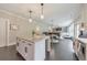 Spacious kitchen with granite countertops, an island with seating, and a view into the living area at 1026 Towne Mill Xing, Canton, GA 30114