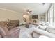 Comfortable living room featuring a stone fireplace, hardwood floors, and a ceiling fan at 1026 Towne Mill Xing, Canton, GA 30114