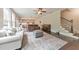 Open-concept living space with hardwood floors, a piano, stairs, and kitchen views at 1026 Towne Mill Xing, Canton, GA 30114