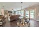 Cozy living room with a dining area, a fireplace, hardwood floors, and lots of natural light at 1026 Towne Mill Xing, Canton, GA 30114