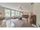 Bright and airy living room with hardwood floors, stone fireplace, an open kitchen, and large windows at 1026 Towne Mill Xing, Canton, GA 30114